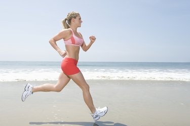 Woman jogging along beach