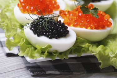 Chicken eggs with red and black fish caviar