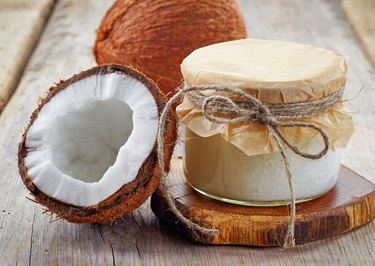 jar of coconut oil and fresh coconuts