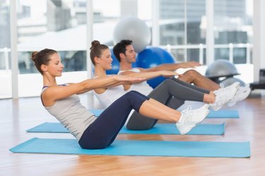 Side view of class doing ab exercises in Mat Pilates studio