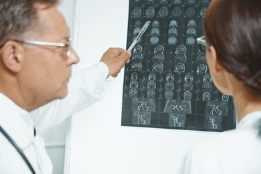 Physicians examine MRI image of human head