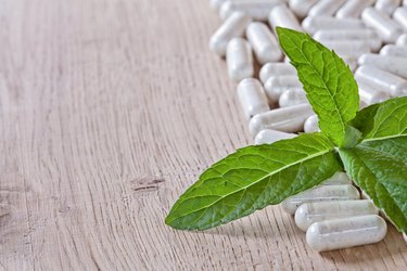 Capsules and a sprig of mint