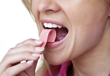 Woman putting gum in her mouth