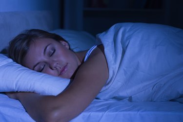 Serene woman sleeping at night