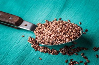 Flax seeds linseed on kitchen spoon