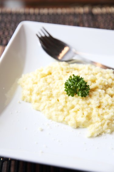 risotto dish with herbs on wood background