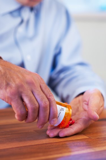 Patient pouring out RX pills into hand