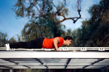 Young fitness specialist ready for press-up exercise