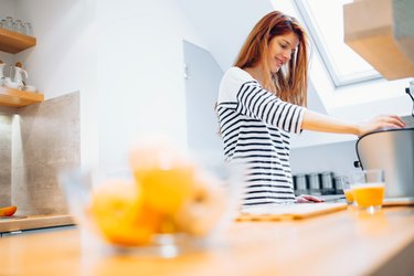 Beautiful woman making organce juice