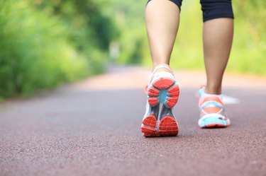 young fitness woman runner /hiker legs at forest trail