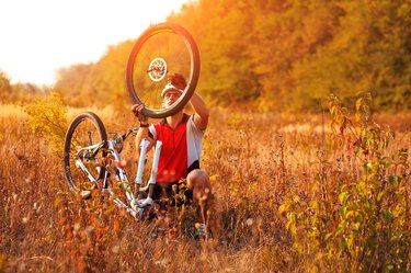 Bike repair. Young man repairing mountain bike