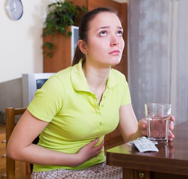 Unhappy woman having stomach aches