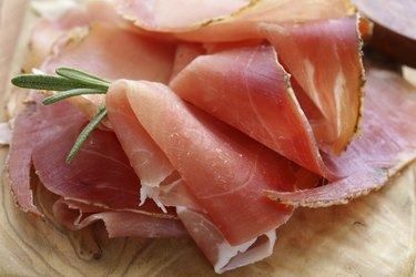 parma ham (jamon) sliced ​​on a wooden board