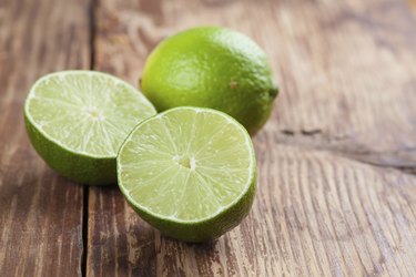 Limes on wooden background