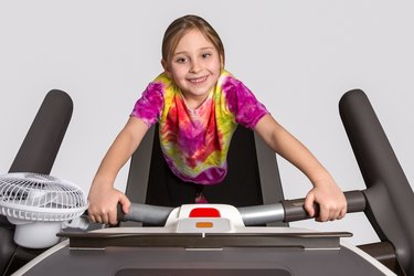 Young Girl Exercising on Treadmill