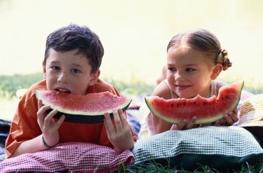 Two Young Children Eating Watermelon