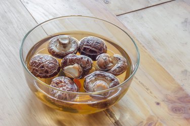Dried shiitake mushroom in transparent bowl with water