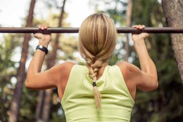 Fit and strong  woman doing pullups