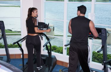 Man and woman exercising on exercise machine in a gymnasium