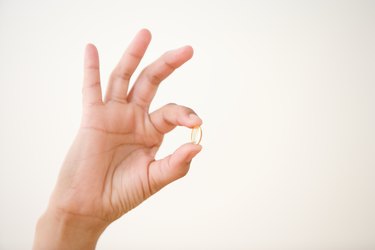 Close up of hand holding vitamin