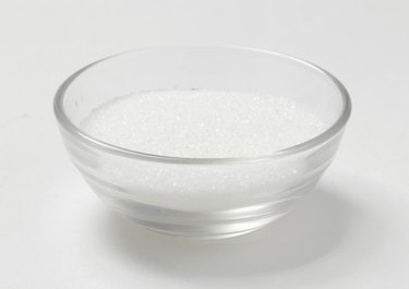 Granulated sugar in a glass bowl, studio shot