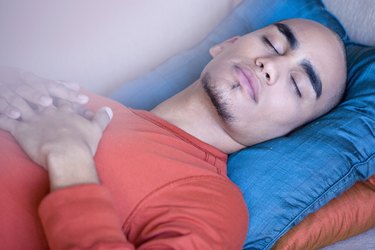 African American man sleeping on sofa