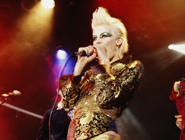 Woman singing into microphone, low angle view