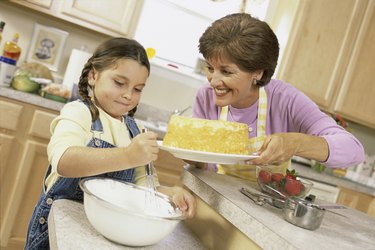 Mother and daughter baking a cake together