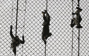 U.S. Army recruits completing an obstacle at Victory Tower during basic combat training.