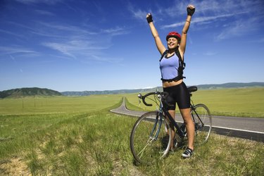 Woman with bicycle in field