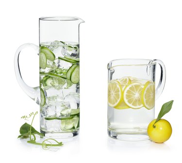 Pitchers of water with cucumber and lemon slices