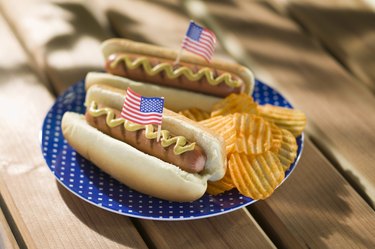 Hot dogs and chips with miniature american flags