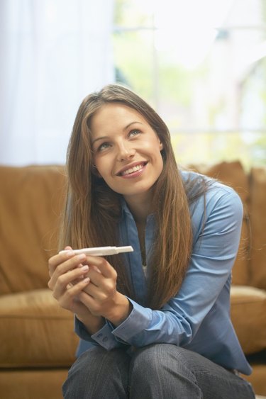 Woman holding home pregnancy test
