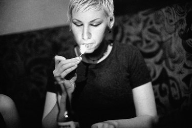 Woman lighting a cigarette