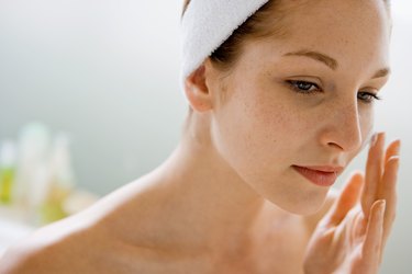 Woman using moisturizing cream