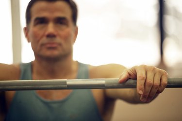 Close-up of a mature man exercising with a barbell