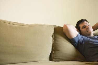 Mature man relaxing on sofa