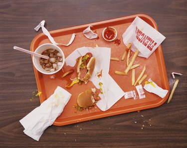 Messy Tray With Eaten Hot Dog, Fries and Cola