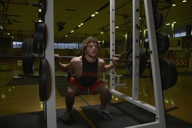 Teenage boy (16-17) weightlifting