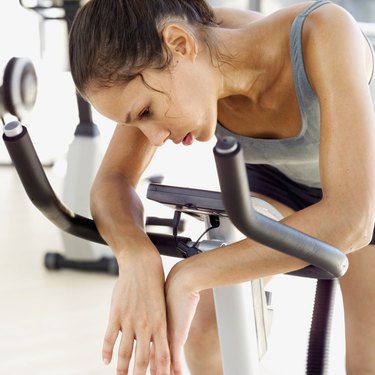 young woman sitting on an exercise bike