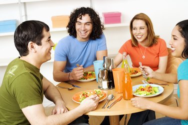 Two young couples eating food