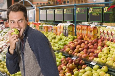 Sneaky man eating an apple