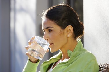 Woman Drinking Water Outside Home