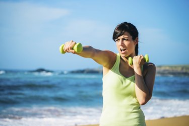 Fitness girl boxing with dumbbells