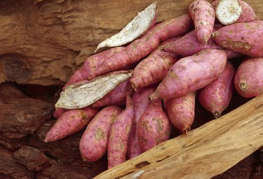 Old potatoes on wooden