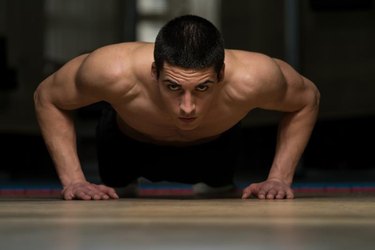 Young Athlete Doing Push-Ups As Part Of gym Training