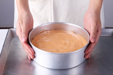 woman holds cake pan