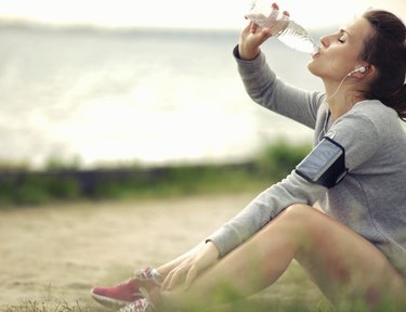 Female Runner Drinking Water