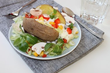 baked potato with colorful salat