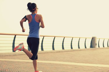 young fitness woman runner running at seaside